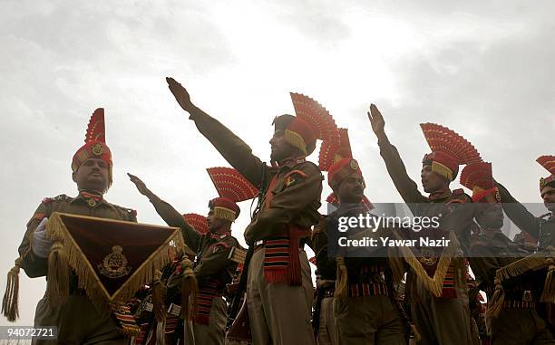 Indian Border Security Force soldiers raise their hands as they take oath during their passing out parade on December 06, 2009 in Humhama, on the...