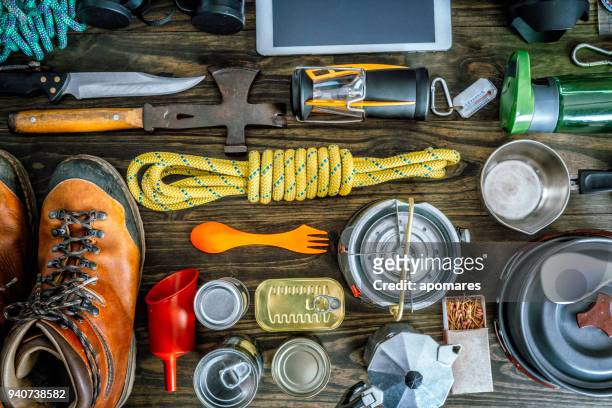 top view of travel equipment and accessories for mountain hiking trip on wood floor - survival supplies stock pictures, royalty-free photos & images