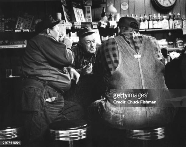 Local men drinking and chatting with the owner of Ole Joe Poe's Tavern in New Athens, Illinois, 1976.
