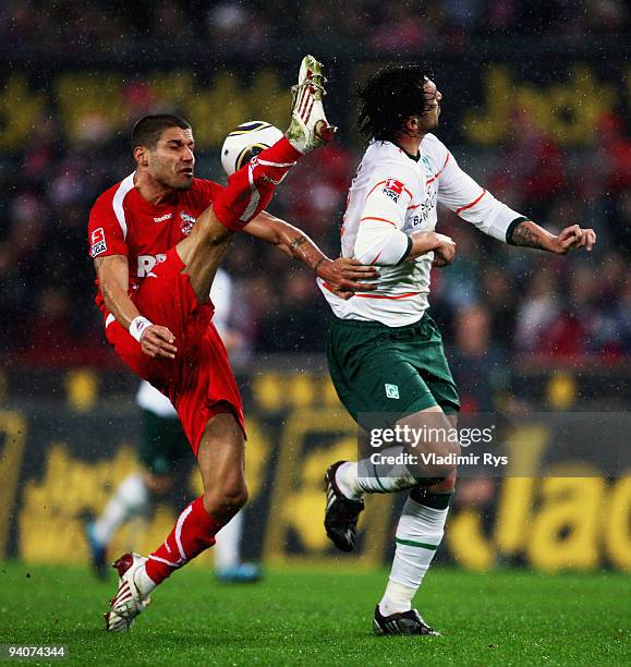 Youssef Mohamad of Koeln and Hugo Almeida of Bremen battle for the ball the Bundesliga match between 1. FC Koeln and SV Werder Bremen at RheinEnergie...