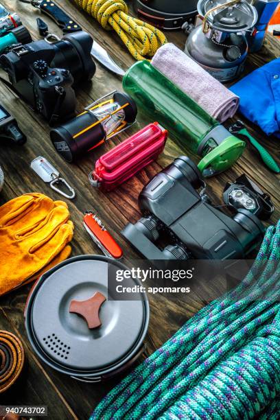 top view of travel equipment and accessories for mountain hiking trip on wood floor - camping equipment stock pictures, royalty-free photos & images