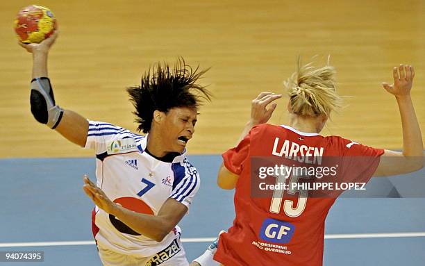 Denmark's Pernille Larsen tries to block France's Allison Pineau during the preliminary round match between France and Denmark at the women's...