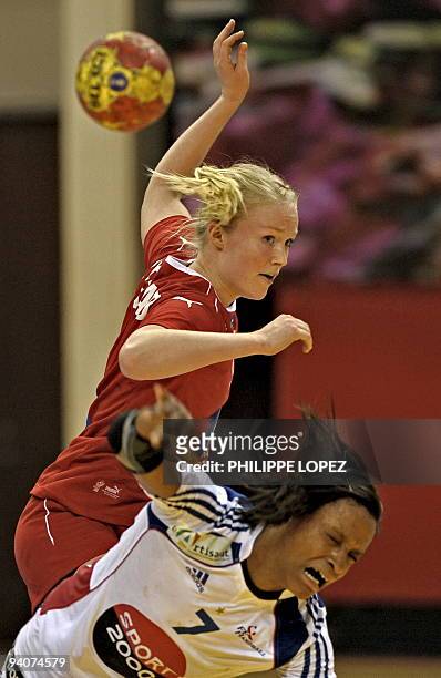 Denmark's Maibritt Kviesgaard blocks a shot from France's Allison Pineau during the preliminary round match between France and Denmark at the women's...