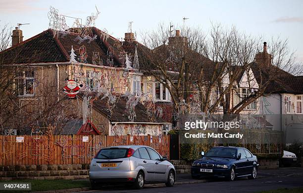 Christmas festive lights adorn a detached house in a suburban street in daylight, December 6, 2009 in Melksham, England. The lights, which involve...