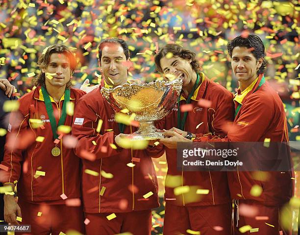 Spanish players David Ferrer team captain Albert Costa Rafael Nadal and Fernando Verdasco celebrate with the Davis Cup trophy at the end of the final...