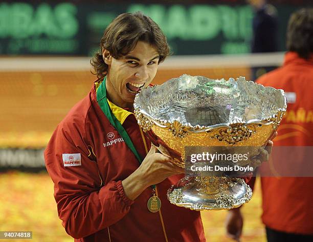 Rafael Nadal of Spain celebrates with the Davis Cup trophy at the end of the final match between Spain and Czech Republic at the Palau Sant Jordi...