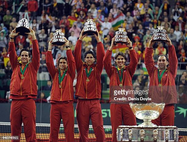 Spanish players Feliciano Lopez , David Ferrer, Fernando Verdasco Rafael Nadal and team captain Albert Costa celebrate with the Davis Cup trophy at...