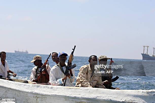 Recent Somali Coast Guard graduates ride an outboard vessel as they carry out a daily patrol near the Mogadishu port, off the coast of the Somali...