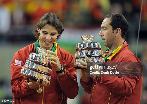 Rafael Nadal of Spain celebrates with team captain Albert Costa after being presented with the Davis Cup trophy at the end of the final match between...