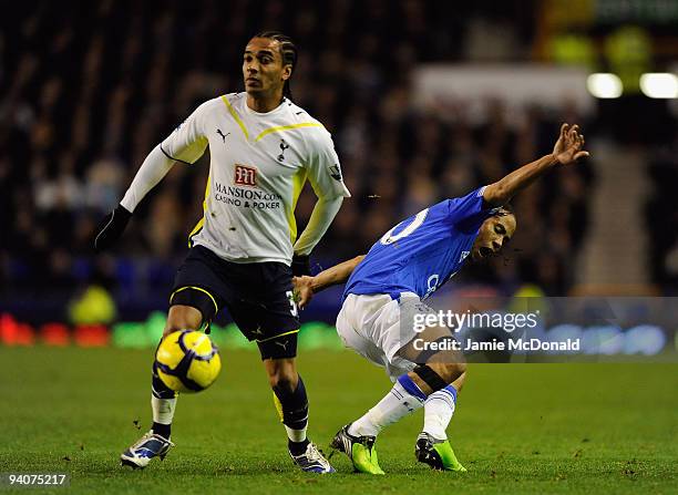 Steven Pienaar of Everton tangles with Benoit Assou- Ekotto of Tottenham Hotspur during the Barclays Premier League match between Everton and...