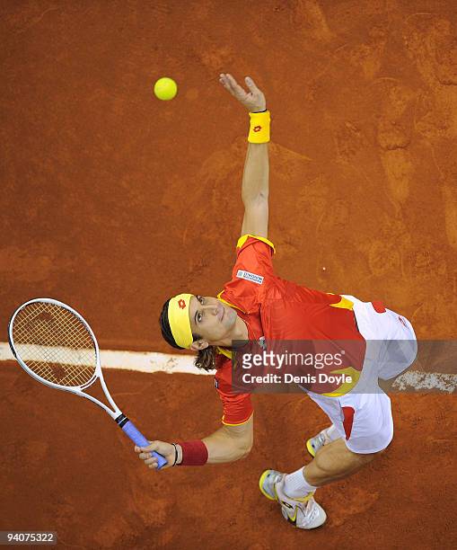 David Ferrer of Spain serves to Lukas Dlouhy of Czech Republic during the fifth match of the Davis Cup final between Spain and Czech Republic at the...