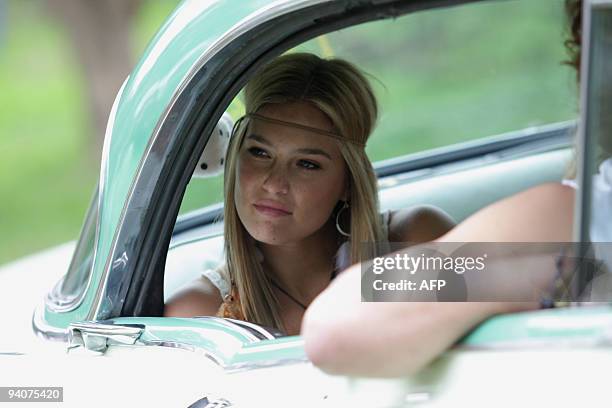 Israeli supermodel Bar Refaeli poses inside a car during a photo session on December 6, 2009 for a new campaign for the Israeli fashion house Fox at...