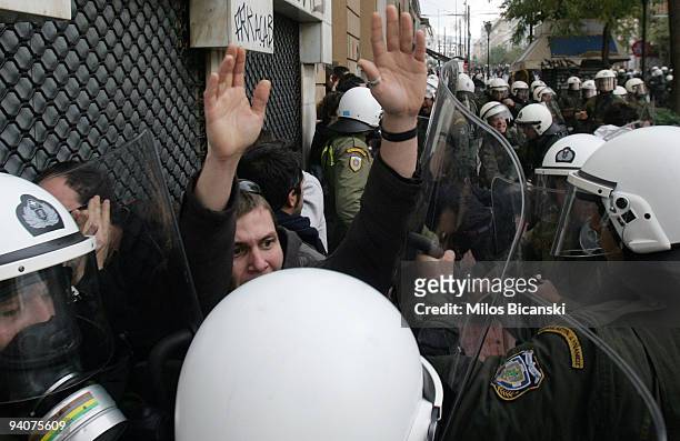 Riot police detain a protestors during a demonstration commemorating the fatal shooting of 15-year-old Alexandros Grigoropoulos' by police a year...