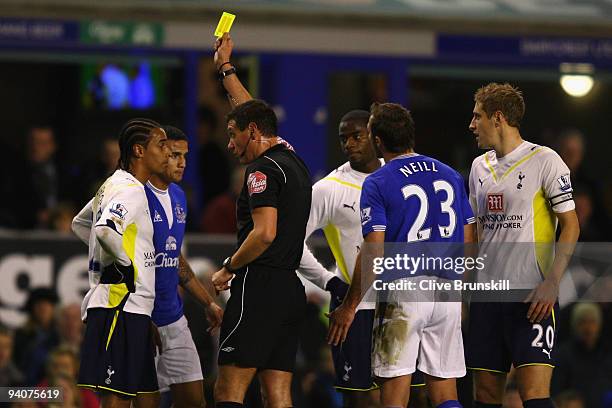 Benoit Assou- Ekotto of Tottenham Hotspur is shown a yellow card by Referee Andre Marriner during the Barclays Premier League match between Everton...