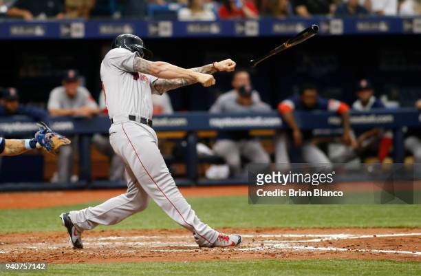 Blake Swihart of the Boston Red Sox tosses his bat into the Tampa Bay Rays' dugout while facing pitcher Jacob Faria of the Tampa Bay Rays during the...