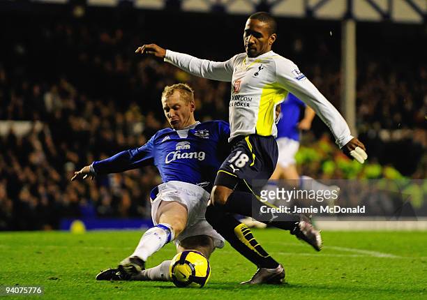 Jermain Defoe of Tottenham Hotspur is tackled by Tony Hibbert of Everton during the Barclays Premier League match between Everton and Tottenham...