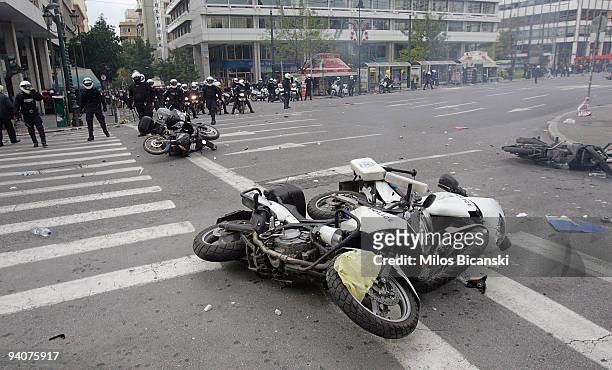 Police motorbikes are damaged during a demonstration commemorating the fatal shooting of 15-year-old Alexandros Grigoropoulos by police a year ago,...