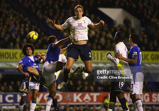 Michael Dawson of Tottenham Hotspur tangles with Lucas Neill of Everton during the Barclays Premier League match between Everton and Tottenham...