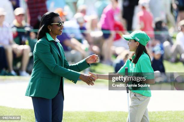 Vanessa Borovilos, participant in the girls 10-11, shakes hands with Condoleezza Rice during the Drive, Chip and Putt Championship at Augusta...