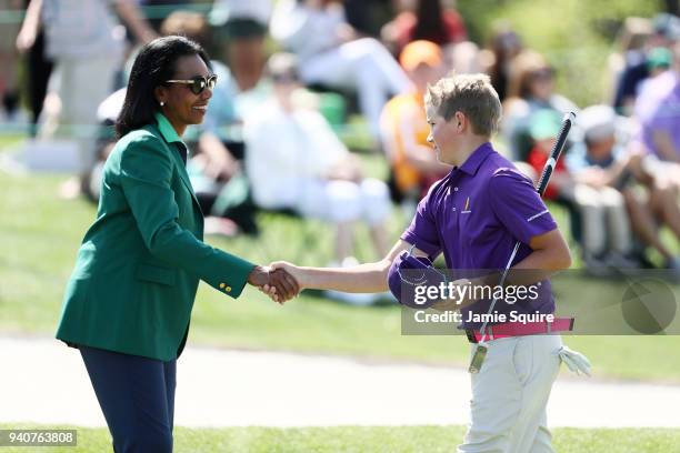 Maybank III, participant in the boys 12-13, shakes hands with Condoleezza Rice during the Drive, Chip and Putt Championship at Augusta National Golf...