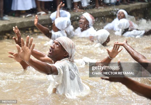 Haitian voodoo followers bathe in a sacred pool during a voodoo ceremony in Souvenance, a suburb of Gonaives, 171 km north of Port-au-Prince, on...