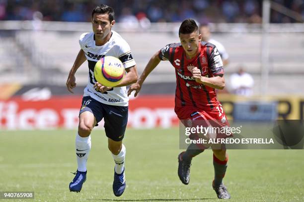Pumas's defender Luis Fuentes vies for the ball with Necaxa's Roberto Alvarado during their Mexican Clausura tournament football match at the...