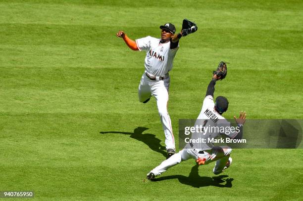 Lewis Brinson of the Miami Marlins makes the catch over Cameron Maybin in the fifth inning against the Chicago Cubs at Marlins Park on April 1, 2018...