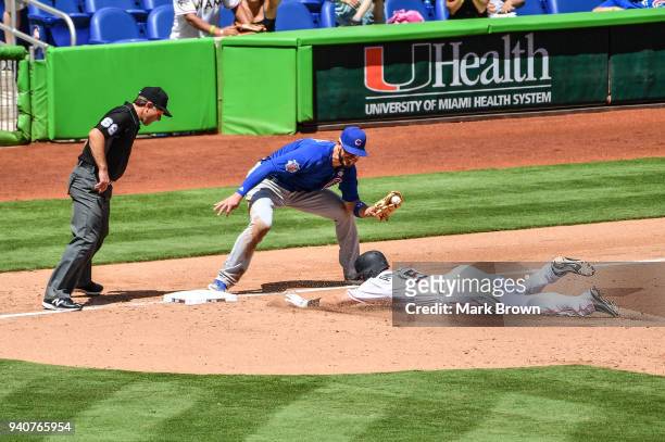 Brian Anderson of the Miami Marlins is tagged out at third by Kris Bryant of the Chicago Cubs in the fifth inning against the Chicago Cubs at Marlins...