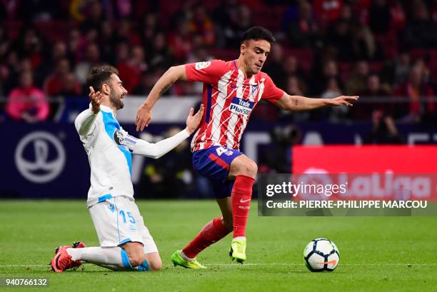 Deportivo La Coruna's Spanish forward Adrian vies with Atletico's Spanish defender Carlos Munoz during the Spanish League football match between...