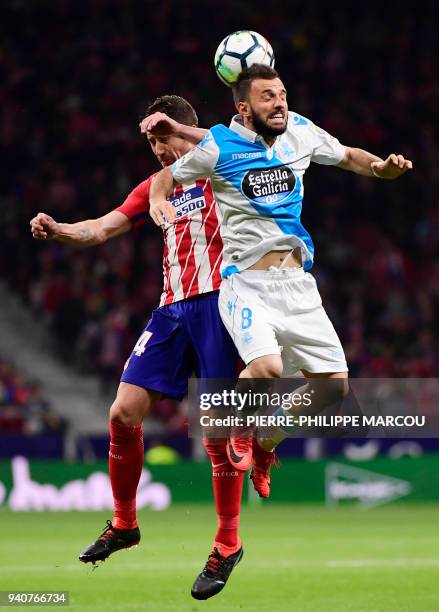 Atletico Madrid's Spanish midfielder Gabi vies with Deportivo La Coruna's Turkish midfielder Emre Colak during the Spanish League football match...