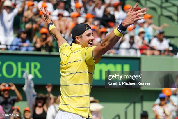 John Isner of the United States celebrates match point after defeating Alexander Zverev of Germany in the men's final on Day 14 of the Miami Open...