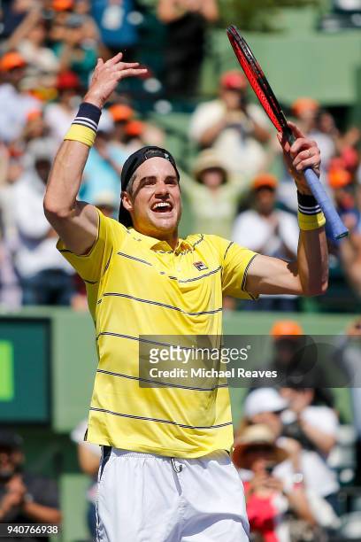 John Isner of the United States celebrates match point after defeating Alexander Zverev of Germany in the men's final on Day 14 of the Miami Open...