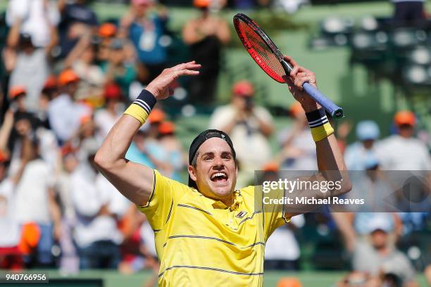 John Isner of the United States celebrates match point after defeating Alexander Zverev of Germany in the men's final on Day 14 of the Miami Open...