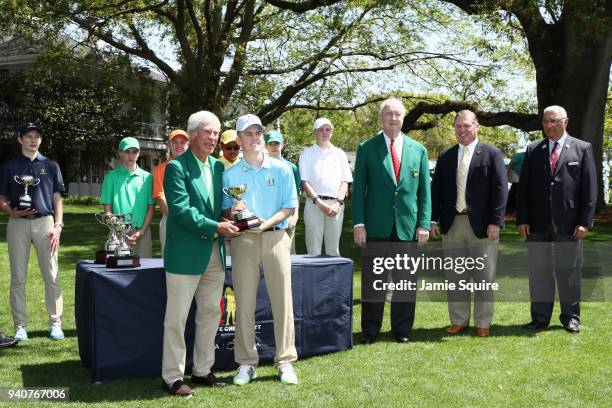 Ben Crenshaw presents Jay Nimmo, participant in the boys 14-15, with his trophy during the Drive, Chip and Putt Championship at Augusta National Golf...