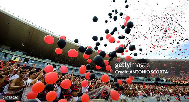 Flamengo supporters cheer their team before the start of the Brazilian Championship final date match against Gremio, at the Maracana stadium on...
