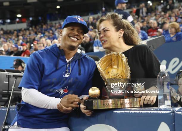 Marcus Stroman of the Toronto Blue Jays shares a laugh with his mother Adlin Auffant after being awarded the Gold Glove Award before the start of MLB...