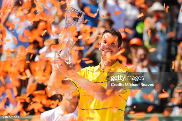 John Isner of the United States poses for a photo with the Butch Buchholz Trophy after defeating Alexander Zverev of Germany in the men's final on...