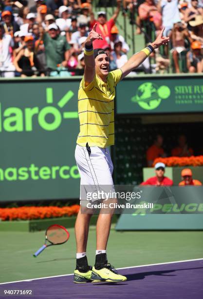 John Isner of the United States celebrates match point against Alexander Zverev of Germany in the mens final during the Miami Open Presented by Itau...