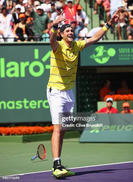 John Isner of the United States celebrates match point against Alexander Zverev of Germany in the mens final during the Miami Open Presented by Itau...