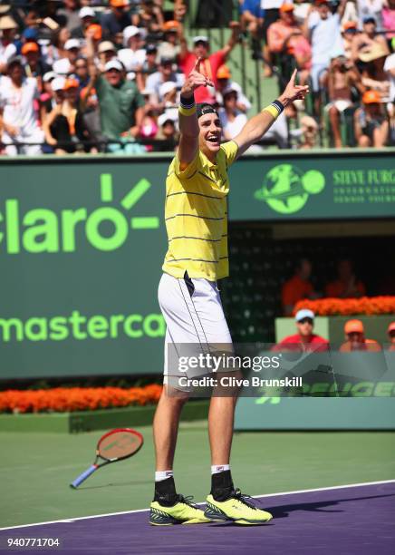 John Isner of the United States celebrates match point against Alexander Zverev of Germany in the mens final during the Miami Open Presented by Itau...