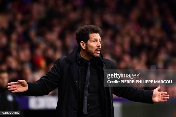 Atletico Madrid's Argentinian coach Diego Simeone gestures during the Spanish League football match between Atletico Club Atletico de Madrid and RC...