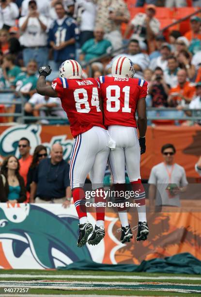 Wide receiver Randy Moss of the New England Patriots celebrates with tight end Benjamin Watson after Moss' 58 yard touichdown reception in the first...