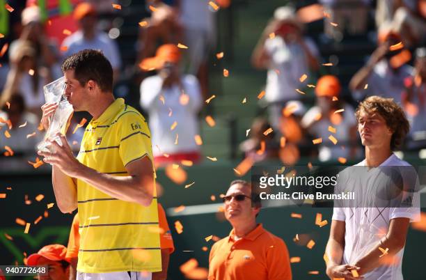 John Isner of the United States kisses the Butch Bucholz trophy after his three set victory against Alexander Zverev of Germany in the mens final...