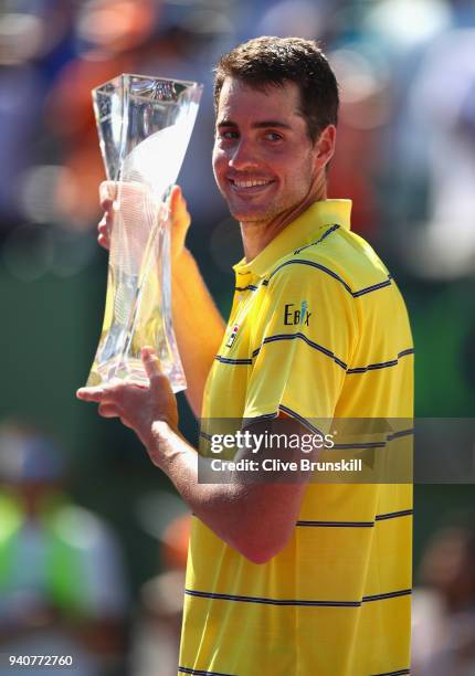 John Isner of the United States holds the Butch Bucholz trophy after his three set victory against Alexander Zverev of Germany in the mens final...
