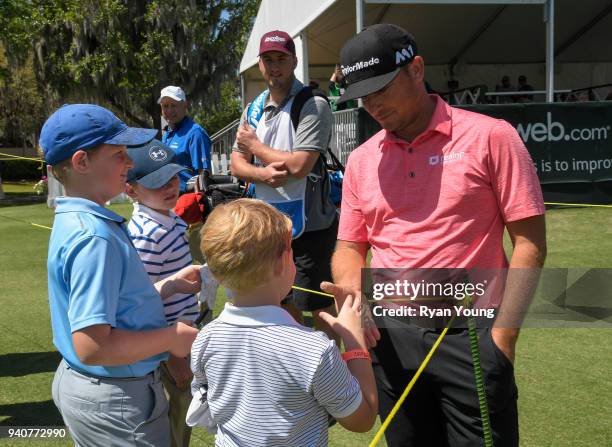 Kyle Thompson signs autographs and talks with young fans during the final round of the Web.com Tour's Savannah Golf Championship at the Landings Club...