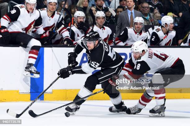 Kevin Gravel of the Los Angeles Kings skates with the puck against Jordan Martinook of the Arizona Coyotes during the game on March 29, 2018 at...