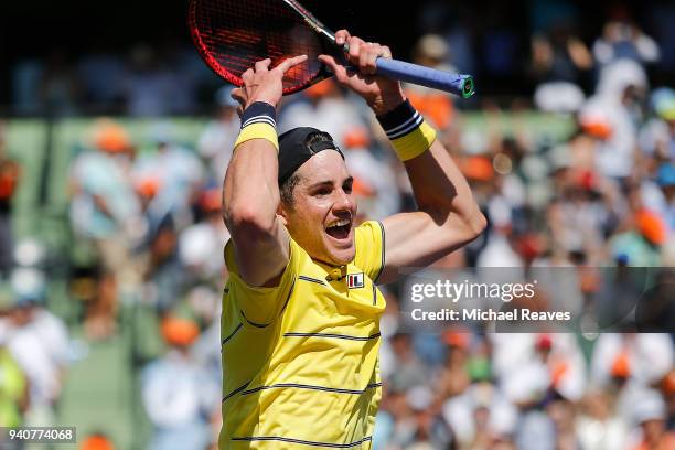 John Isner of the United States celebrates match point after defeating Alexander Zverev of Germany in the men's final on Day 14 of the Miami Open...