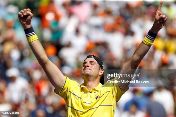 John Isner of the United States celebrates match point after defeating Alexander Zverev of Germany in the men's final on Day 14 of the Miami Open...