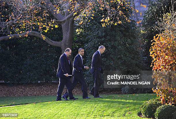 President Barack Obama walks to the Oval Office of the White House with senior advisor David Axelrod and White House legislative affairs director...