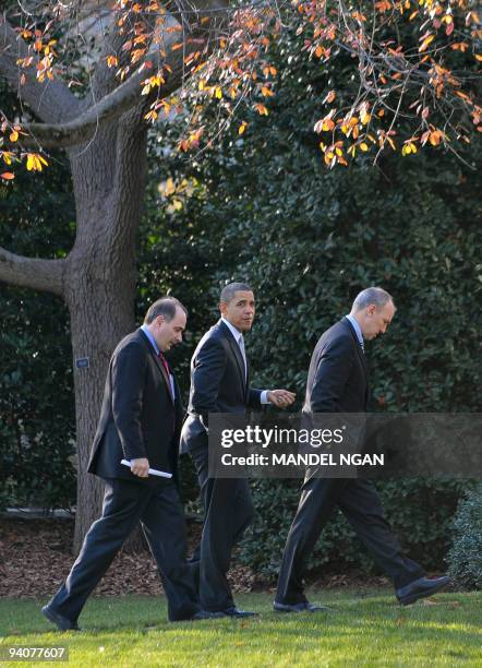 President Barack Obama walks to the Oval Office of the White House with senior advisor David Axelrod and White House legislative affairs director...